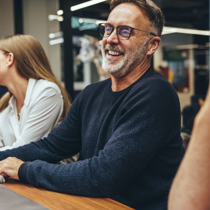 Mature,Businessman,Attending,A,Meeting,With,His,Colleagues.,Happy,Mature